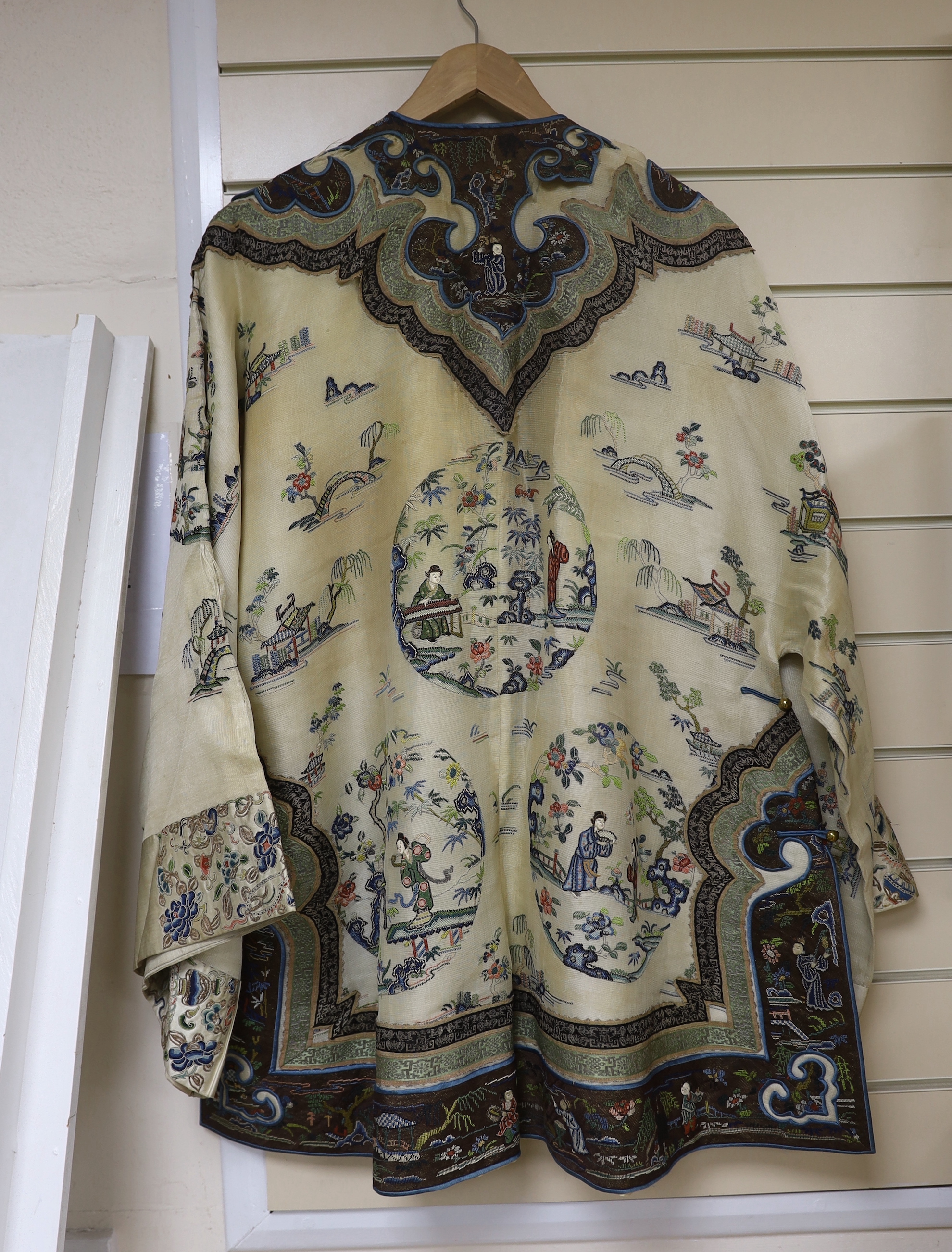 A late 19th/early 20th century Chinese gauze summer robe embroidered with flowers, figures and pagodas, 85cm high